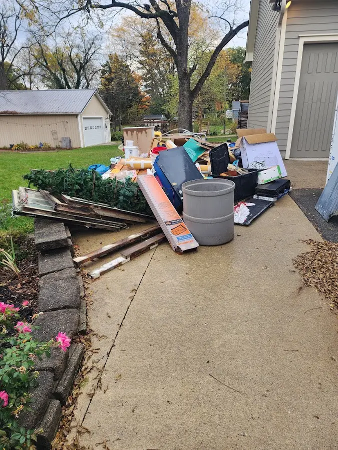 Dumpster being loaded with debris for Estate Cleanout Dumpster Rental in Harvey